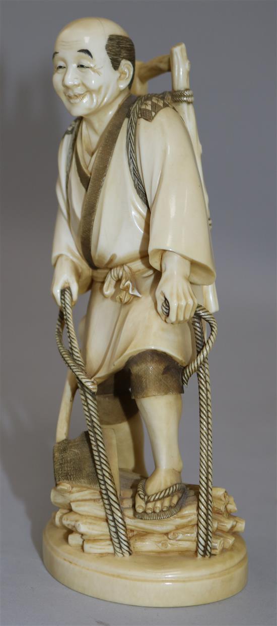 A Japanese ivory figure of a woodsman, early 20th century, 18cm